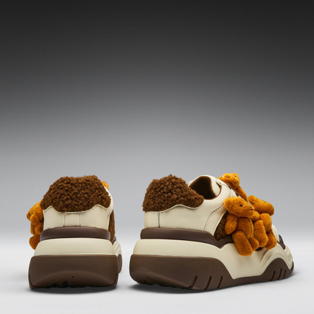 Pair of shoes with teddy bear design on a gray background