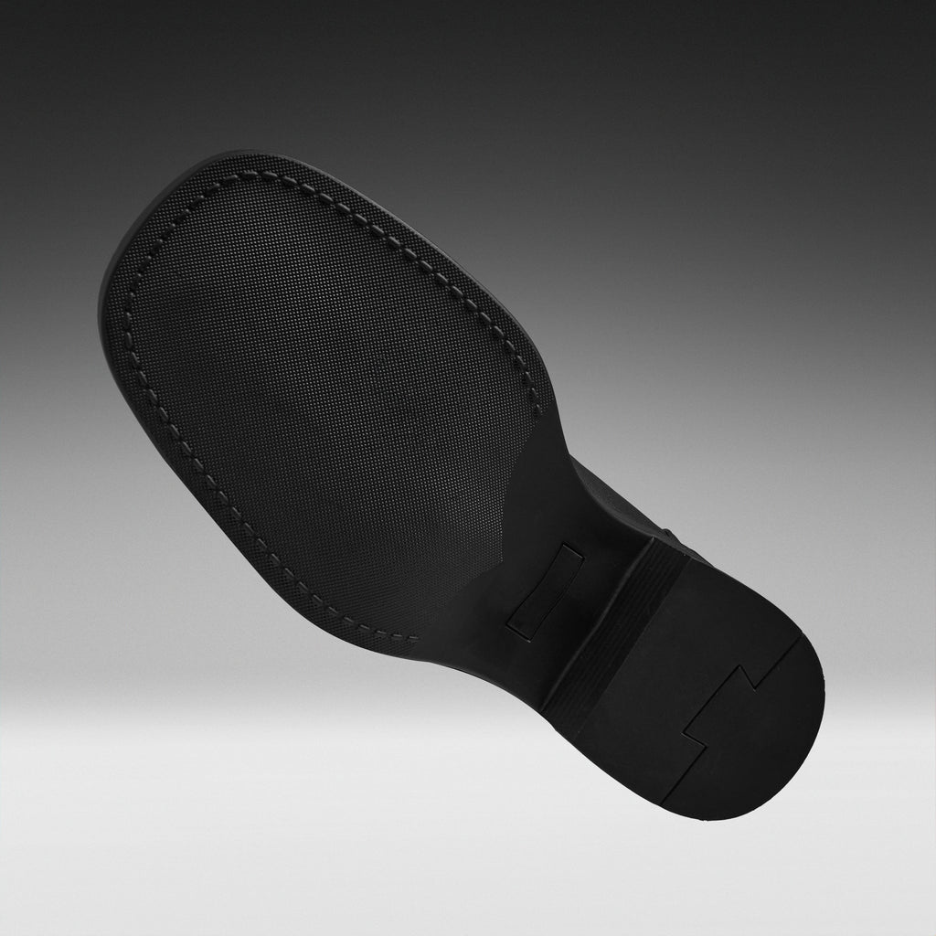 A close-up of a black shoe sole, showing the textured tread and stitched edge, set against a dark gray gradient background.